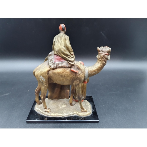 69 - An Austrian, Bergmann style cold painted Table Lighter in the form of a Carpet Seller with camel and... 