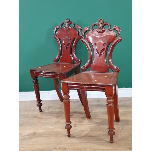 699 - A pair of mahogany Hall Chairs with shaped backs, on turned front supports, A/F. (R9).