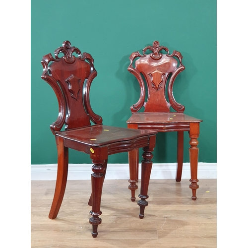 699 - A pair of mahogany Hall Chairs with shaped backs, on turned front supports, A/F. (R9).