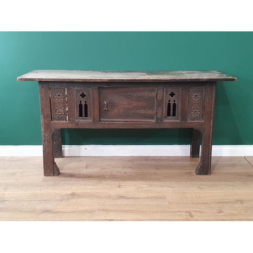 719 - An oak Serving Table with rectangular top, fitted cupboard door flanked by carved and pierced panels... 