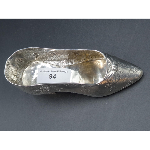 94 - A large Continental silver Shoe embossed numerous cupids playing in a landscape, Import mark London ... 