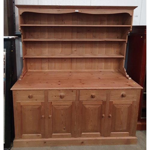 399 - A modern pine Dresser and Rack, the base fitted four drawers above four cupboard doors, on plinth ba... 