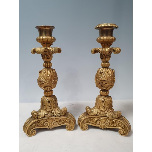 466 - A pair of French ormolu Candlesticks with leafage designs on scrolled supports (One missing its Scon... 