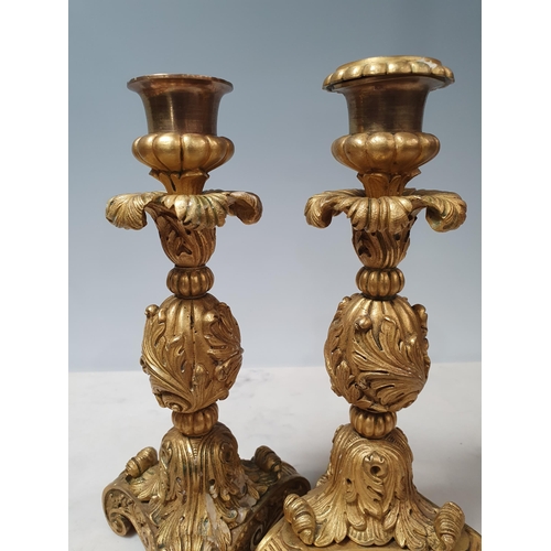 466 - A pair of French ormolu Candlesticks with leafage designs on scrolled supports (One missing its Scon... 