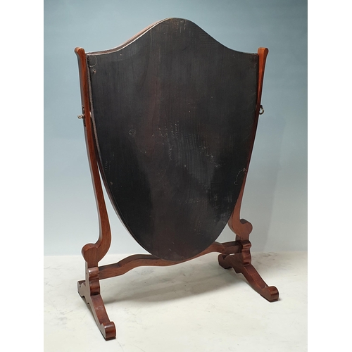 638 - A mahogany framed Shield Shaped Dressing Mirror on shaped supports. (R8).