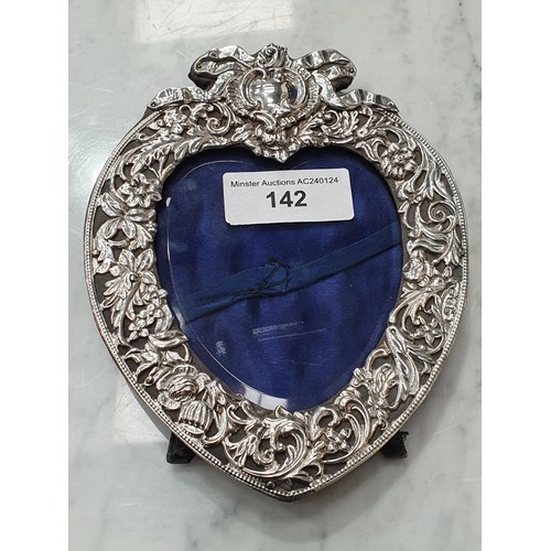 142 - A Victorian silver heart shape Photograph Frame wit ribbon surmount, floral and leafage embossing, B... 