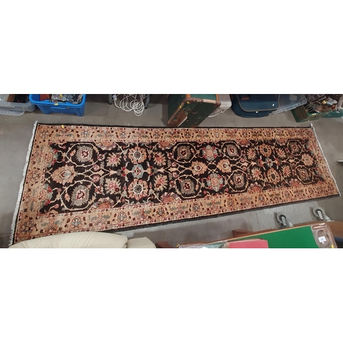 93 - A Runner on beige and brown ground, with multi borders and central floral designs, 9ft 11