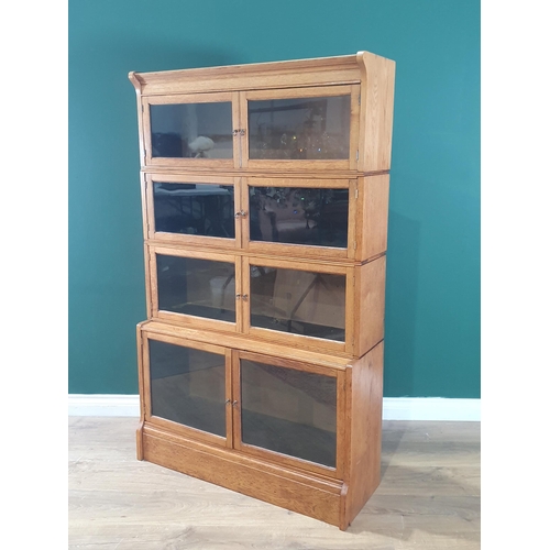 1 - A light oak four tier glazed Stacking Bookcase (replacement backboards), 4ft 10in High x 2ft 11in Wi... 