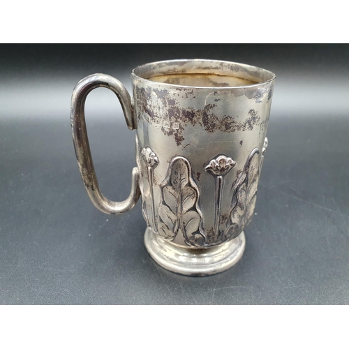 102 - A George V Art Nouveau silver Christening Mug  with leafage and floral embossing, Birmingham 1912