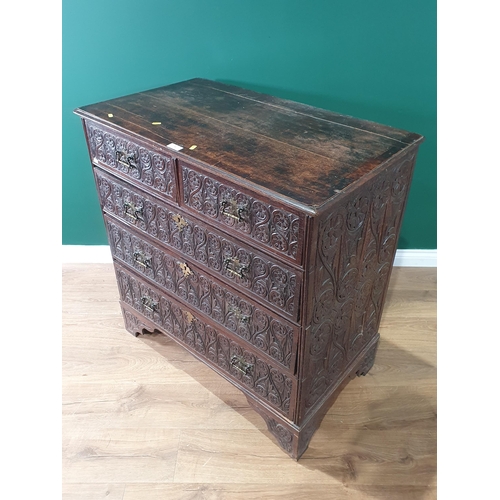 11 - An 18th Century oak Chest of two short, three long Drawers with later carved decorations, raised on ... 