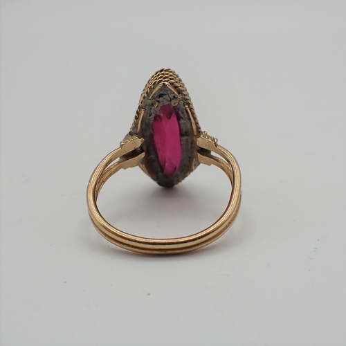 175 - A synthetic Ruby Dress Ring rubover-set marquise-cut stone, ring size J, stamped 750, approx 4.30gms