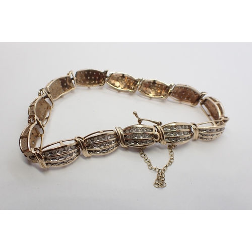 183 - A Diamond Bracelet constructed from thirteen links each channel-set three rows of brilliant-cut ston... 