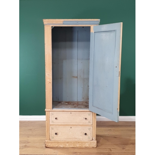 21 - A Victorian scumble painted pine Wardrobe, the panel door above two long drawers, raised on plinth b... 