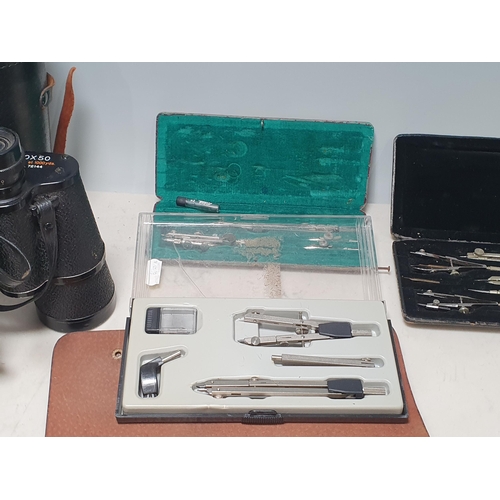 218 - A pair of Tecnar 10 x 50 Binoculars in case, boxed Drawing Instruments, and a set of metal Spats in ... 