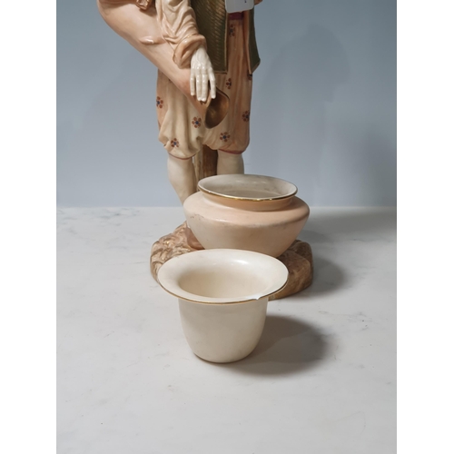 234 - A Royal Worcester figure of a Water Carrier, standing with bowl at foot 12in H, loose bowl A/F