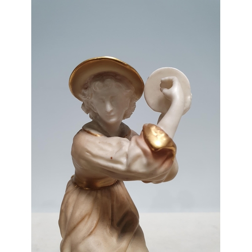 235 - A Royal Worcester figure of a lady seated on a rustic tree trunk holding a tambourine, no 1083, 6 1/... 