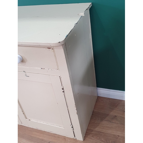 26 - A cream painted Dresser Base fitted three drawers above three panel cupboard doors, 2ft 11