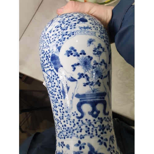 377 - A Chinese blue and white ceramic Vase with figures supporting vases, and all over bird and floral pa... 