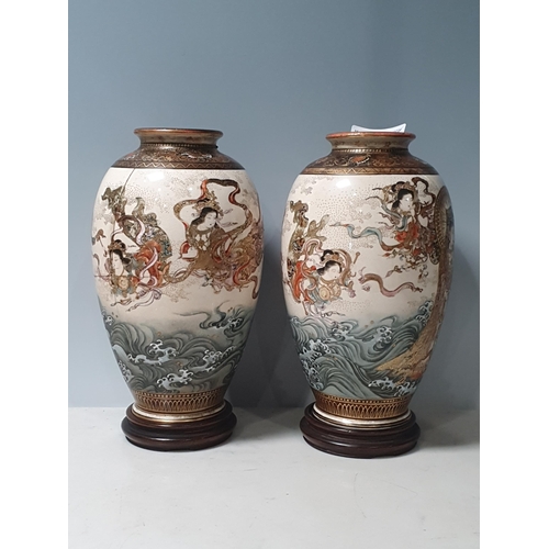 390 - A pair of Satsuma Vases with Figure and Wave decorations on circular hardwood stands character marks... 