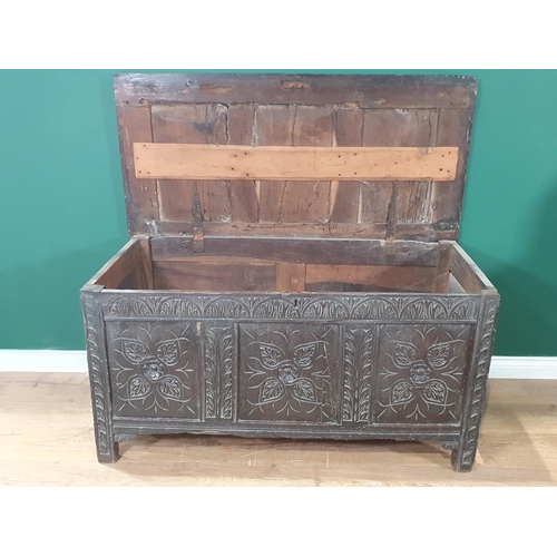 499 - A 17th Century joined oak Coffer with sunken three panel lid, with later hinges, above leafage carve... 