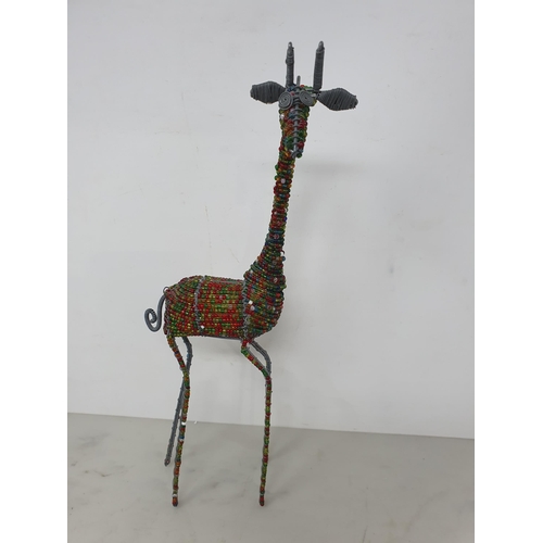 57 - A Collection of African Souvenirs, Ethnica, etc including numerous giraffe figures, pictures, soft t... 