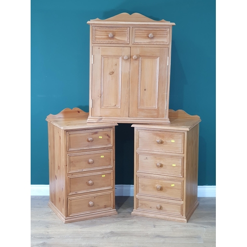 581 - A pair of pine Bedside Chests and a Pine Cupboard fitted drawers and doors (R8)