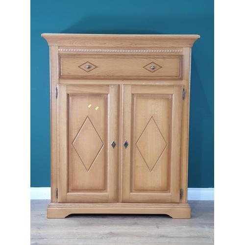 582 - A modern Cupboard, with single long drawer above pair of cupboard doors with diamond decoration, enc... 