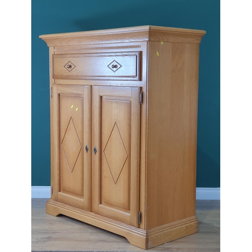 582 - A modern Cupboard, with single long drawer above pair of cupboard doors with diamond decoration, enc... 