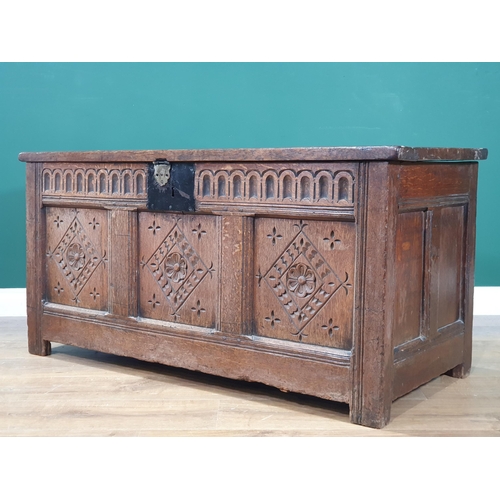 593 - An antique oak Coffer with with sunken three panel lid, above carved frieze and three panel front, A... 