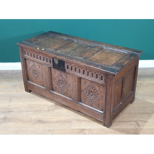 593 - An antique oak Coffer with with sunken three panel lid, above carved frieze and three panel front, A... 