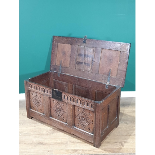 593 - An antique oak Coffer with with sunken three panel lid, above carved frieze and three panel front, A... 