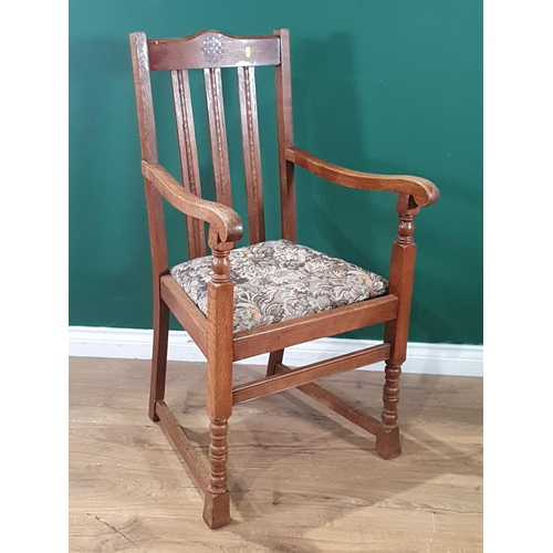 63 - A 1920's oak Elbow Chair with arched top rail having inlaid circular panel. vertical rail back, upho... 