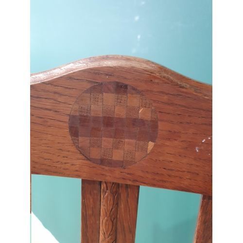 63 - A 1920's oak Elbow Chair with arched top rail having inlaid circular panel. vertical rail back, upho... 