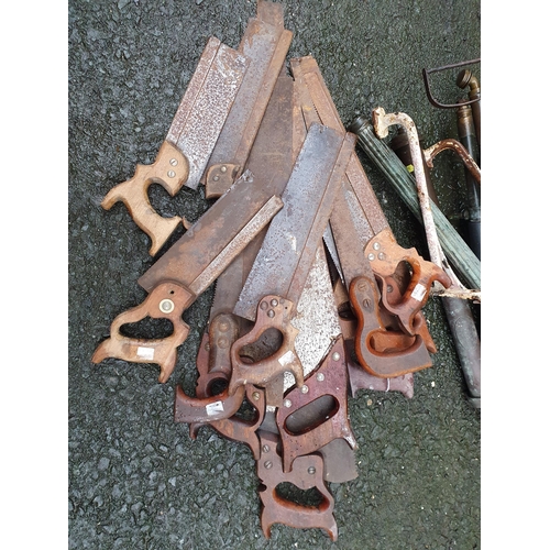 68 - A quantity of Wood Saws and a quantity of vintage Garden Sprayers