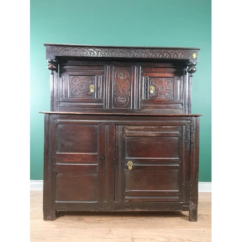 695 - An antique oak Deuddarn with pair of carved panelled doors above another pair of panelled doors, 4ft... 