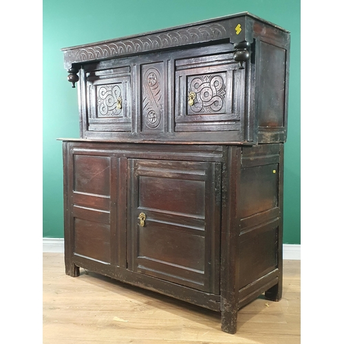 695 - An antique oak Deuddarn with pair of carved panelled doors above another pair of panelled doors, 4ft... 