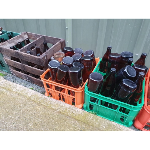 71 - A collection of brown glass Bottles and some vintage Crates