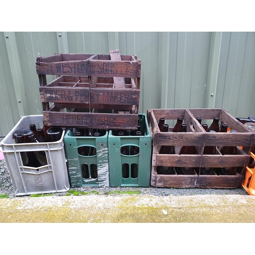 71 - A collection of brown glass Bottles and some vintage Crates