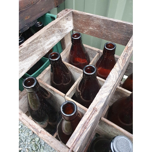 71 - A collection of brown glass Bottles and some vintage Crates