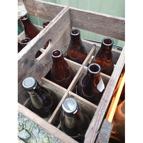 71 - A collection of brown glass Bottles and some vintage Crates