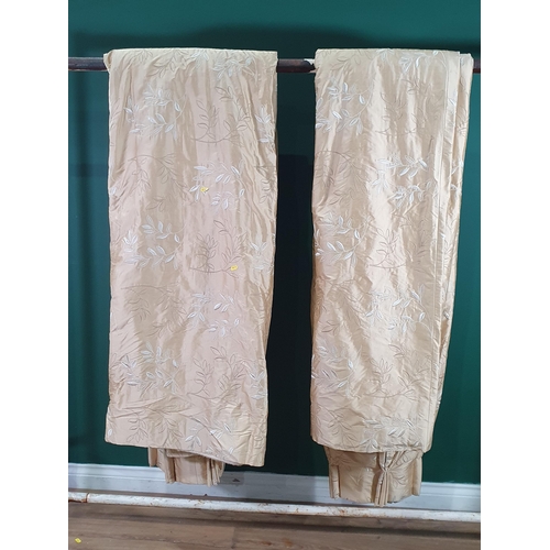 717 - A pair of beige Curtains with raised white and gold leafage design, approx 8ft 8in drop,  4ft 1in wi... 