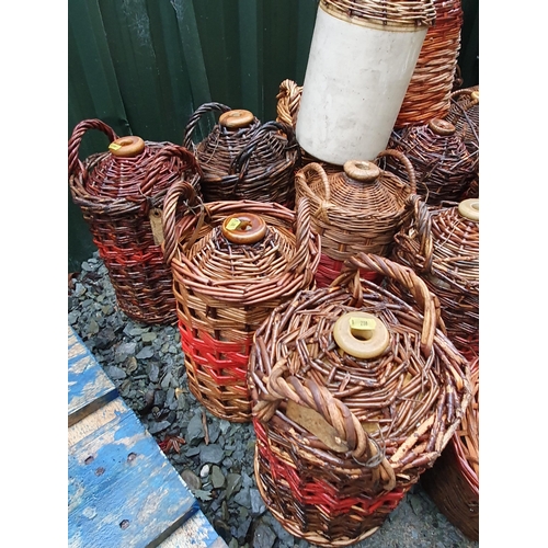 78 - A quantity of cane covered stoneware Jars and some glass Jars