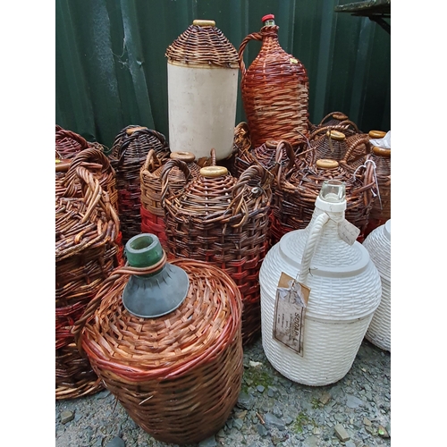 78 - A quantity of cane covered stoneware Jars and some glass Jars