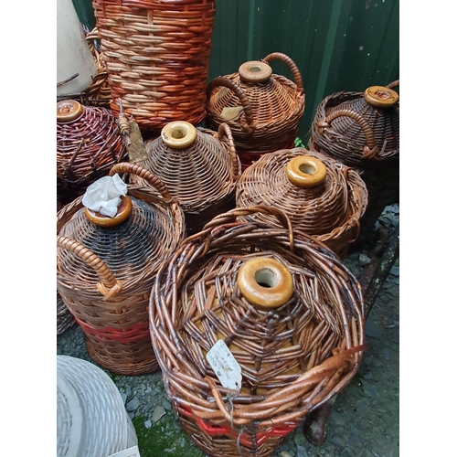 78 - A quantity of cane covered stoneware Jars and some glass Jars