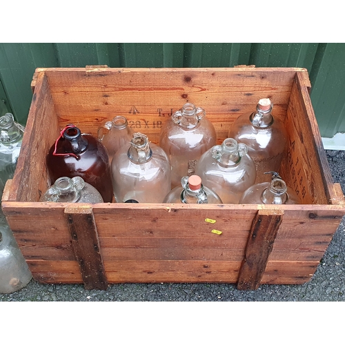 80 - A large quantity of glass Demi Johns in two wooden boxes