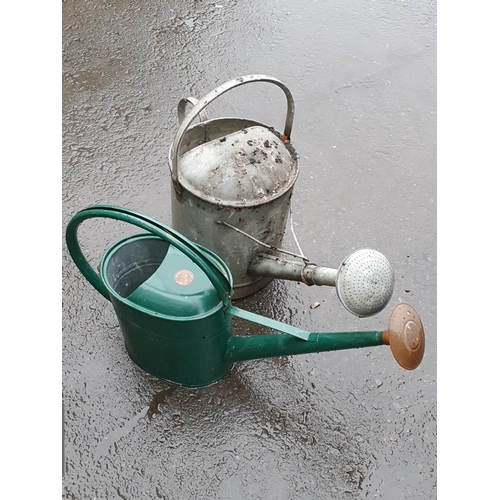 83 - A quantity of Garden Tools, two Watering Cans, a galvanised 