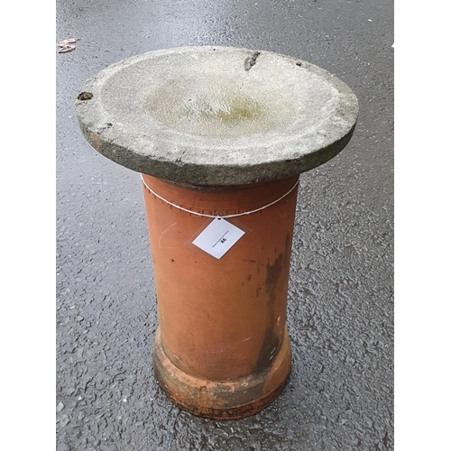 86 - A reconstituted Bird Bath resting on a terracotta Chimney Pot, and a rectangular galvanised Water Ta... 