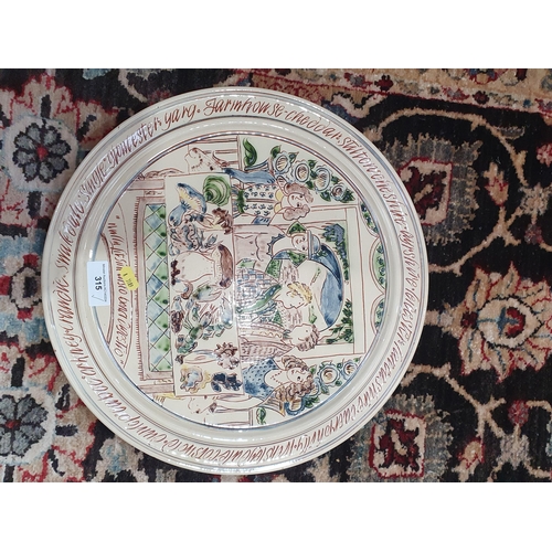 315 - A Mary Wondrausch double sided glazed pottery Cheese Platter depicting figures seated at a table, th... 