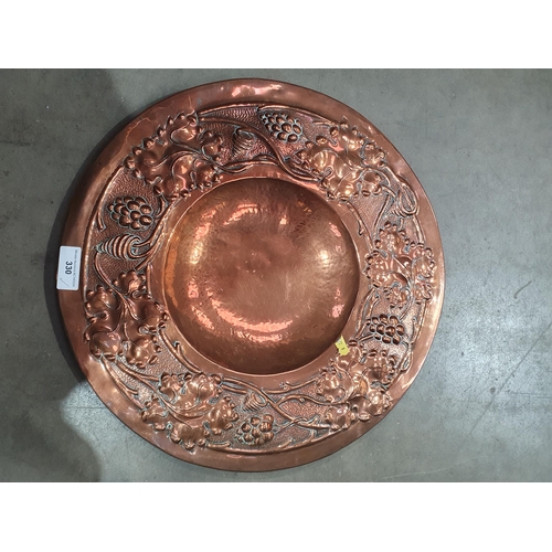 330 - A Copper Charger with border of grapes and vine leaves, 1ft 6