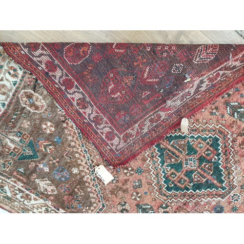 439 - An old Qashqai Rug with floral border and central lozenge on a red ground, faded 5ft 8in x 4ft 5in (... 